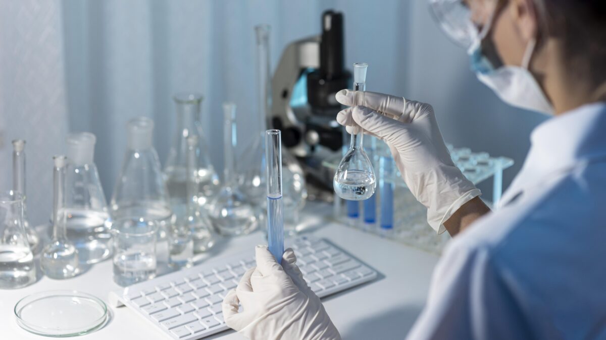 close-up-researcher-holding-glassware-1200×675